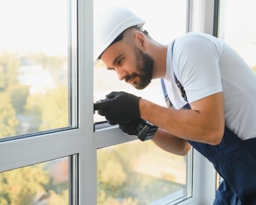 handyman-adjusting-white-pvc-plastic-window-indoors-worker-using-screwdriver-r handyman-adjusting-white-pvc-plastic-window-indoors-worker-using-screwdriver-r